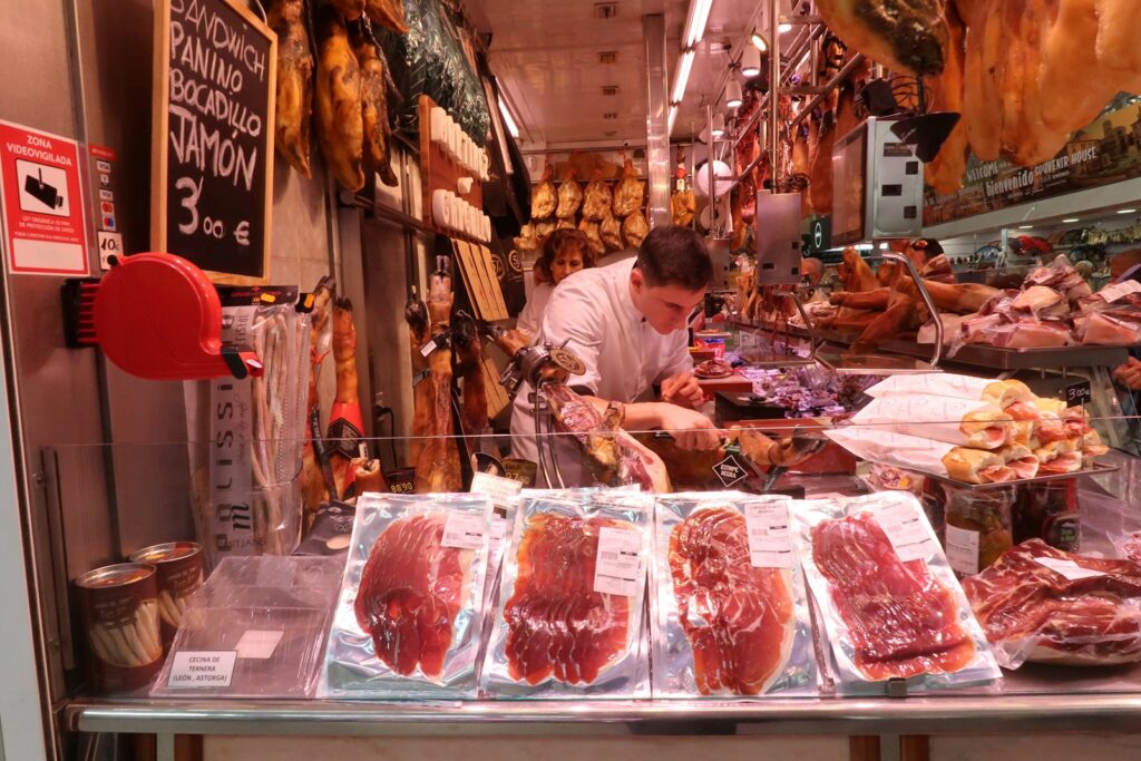 man slicing raw meat